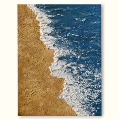 an aerial view of the beach with waves coming in from the ocean and sand on the shore