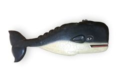 a black and white ceramic fish with an open mouth on it's back end