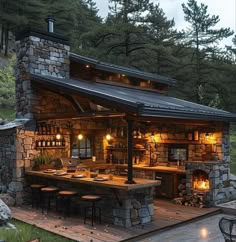 an outdoor kitchen is lit up at night