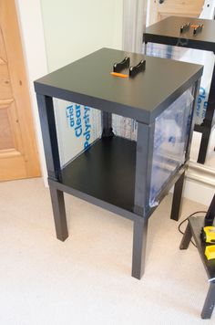 a black table sitting on top of a carpeted floor