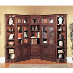 a large bookcase with many books on it in the corner of a living room