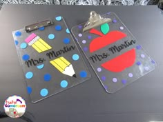 two plastic clipboards with magnets on them that read, mrs martin and miss martin