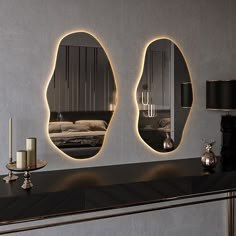 three mirrors on the wall above a table with candles and a candle holder in front of it