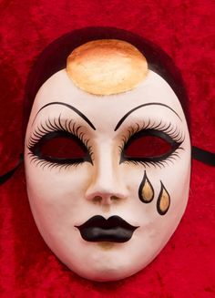 a close up of a mask with food on it's forehead and eyeliners