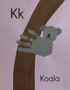 a handprint koala is on the side of a tree