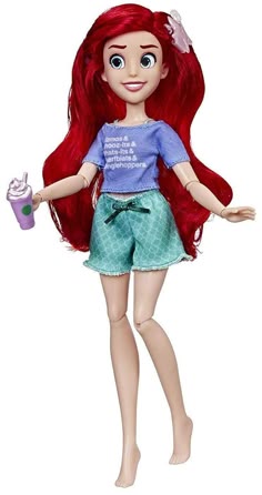 the little mermaid doll has red hair and is holding a drink in her hand with both hands