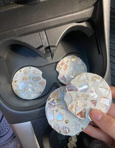 a person is pressing buttons on a car's air vent in the back seat