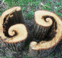 two pieces of wood that have been cut in half and are sitting on the ground