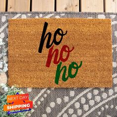 a door mat with the words ho noo on it next to a potted plant