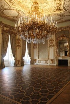 an ornate room with chandelier and curtains