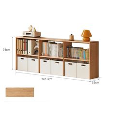 a book shelf with drawers and bins next to a lamp