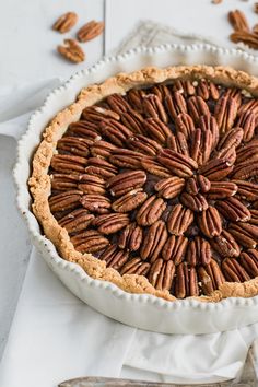 a pie with pecans in it sitting on a table