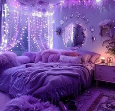 a purple bedroom with lights and pillows on the bed