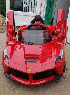 a red sports car parked in front of a house