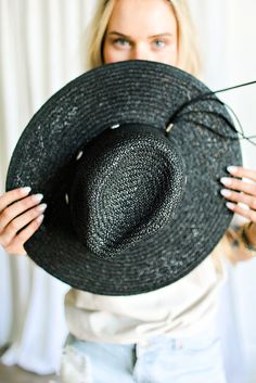 Our Bandera straw hat fits in perfectly with your spring and summer wardrobe, whether at the pool, beach or a concert! On trend w/ a western vibe, classic, chic - everything you've ever wanted in a hat. Featuring a molded crown with a pinched 10cm brim and hand woven straw, it's embellished with a faux leather and silver antique button trim. Finished off with a tassel at the back. -Rancher style hat with a chill & casual vibe-Brim is flexible but holds its shape-Coordinating faux leather band-Pi Western Straw Hat Bands For Summer, Black Hat Bands For Summer Vacation, Black Hat Band For Summer Vacation, Black Hat Bands For Vacation, Summer Vacation Black Hat Bands, Black Toquilla Straw Fedora For The Beach, Woven Fedora Straw Hat For Summer, Summer Woven Fedora Straw Hat, Black Western Hat For Summer