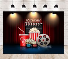 an image of a movie scene with popcorn, film reel and soda on the table