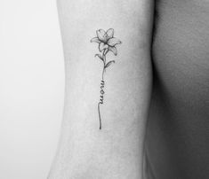 a woman's arm with a single flower tattoo on the left side of her body