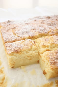 some type of cake sitting on top of a piece of paper with powdered sugar