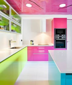 a kitchen with multicolored cabinets and counters