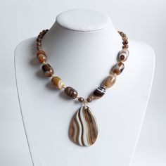 * 20mm large brown banded Agate semi-precious beads * 8mm brown fire Agate semi-precious beads * 10 double sided 14k Gold plated spacers  * 4mm brown Agate beads * Bronze Miyuki spacer beads * 40x60mm large banded agate pendant * The rest of the metals used in this product are 14k Gold Filled (GF 1/20th) * Necklace Length : 20"/51cm What is GOLD FILLED? GOLD FILLED (GF 1/20TH) is a USA industry standard that legally requires 1/20th or 5% pure gold by weight. It's a strictly regulated process tha Brown Carnelian Beaded Jewelry, Brown Agate Beads For Jewelry Making, Brown Gemstone Beaded Necklace, Brown Gemstone Beaded Necklaces With Round Beads, Brown Gemstone Beaded Necklace With Round Beads, Brown Beaded Agate Jewelry, Brown Agate Beaded Jewelry, Spiritual Brown Agate Beads, Brown Gemstone Beads And Cabochons