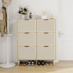 a white cabinet sitting next to a pair of shoes