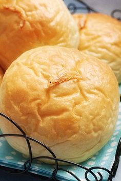 three buns sitting on top of a blue and white plate next to each other