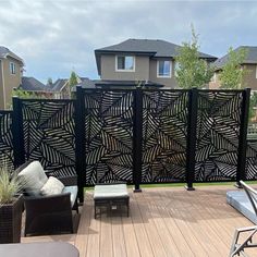 an outdoor deck with furniture and privacy screens