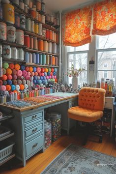 a room filled with lots of crafting supplies and colorful items on the wall above it