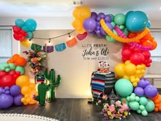 balloons and streamers decorate the entrance to a baby's first birthday party at willow, texas