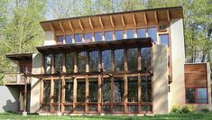 a large house with lots of windows in the front and back of it's walls