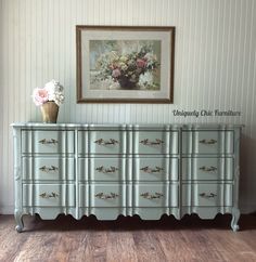 an antique dresser with flowers on top