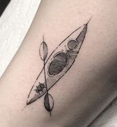 a black and white photo of a small tattoo on the leg of a woman's thigh