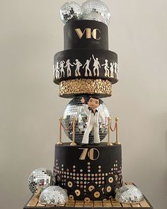 a three tiered cake with disco balls on top