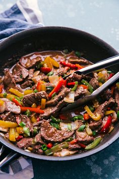 a skillet filled with beef and peppers