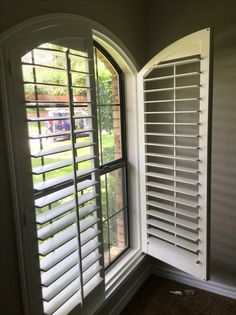 an open window with shutters on the outside