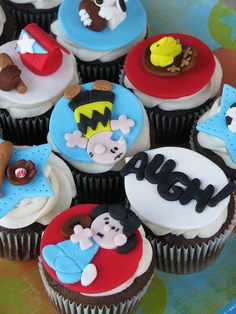 many cupcakes are decorated with cartoon characters