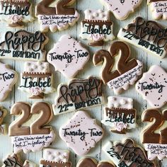 decorated cookies with happy birthday and twenty two - year names are arranged on a table