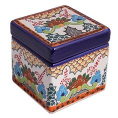 a colorful box with an intricate design on the lid and bottom, sitting against a white background