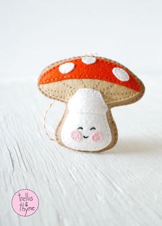 a mushroom broccoli ornament on a white surface with a cute face