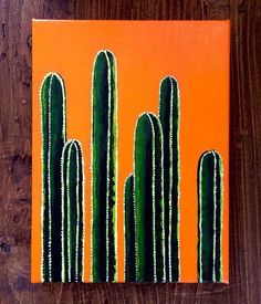 an orange and green cactus painting on wood