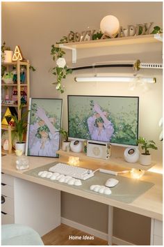 two computer monitors sitting on top of a desk next to each other with candles in front of them