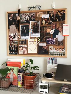 a bulletin board with pictures, photos and other things on it next to a laptop