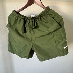 Green Nike Packable Shorts. They Can Be Worn As Swim Trunks Or Casual Athleisure. Never Worn As A Swim Trunk. Only Wore A Couple Of Times. In Great Condition Green Athleisure Bottoms For Outdoor, Green Sportswear Bottoms For Outdoor Activities, Functional Nike Bottoms For Summer, Sporty Nylon Khaki Shorts, Green Cargo Sports Shorts, Sporty Khaki Nylon Shorts, Green Outdoor Bottoms With Drawstring, Green Drawstring Bottoms For Outdoor, Casual Green Nylon Bottoms