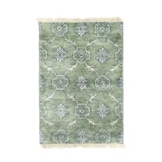 a green rug with blue and white designs on it