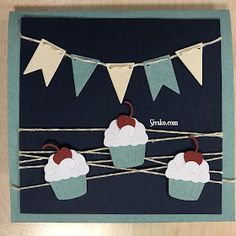 a card with three cupcakes and bunting on the string, hanging from strings