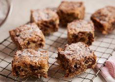 several pieces of dessert sitting on top of a cooling rack