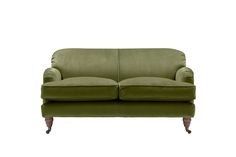 a green couch sitting on top of a white floor