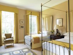 a bedroom with two beds and yellow curtains