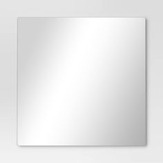 a white square mirror on the wall with no reflection or light in front of it