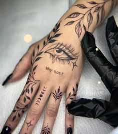 a woman's hand with tattoos on it and an eye drawn in the middle